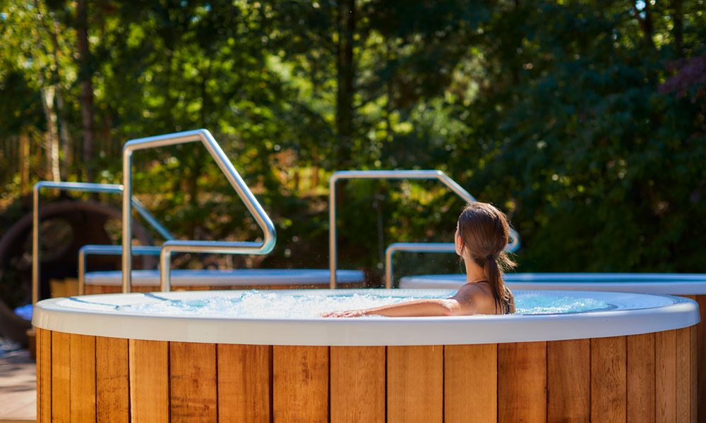 Woman sitting in a bubbling hot tub