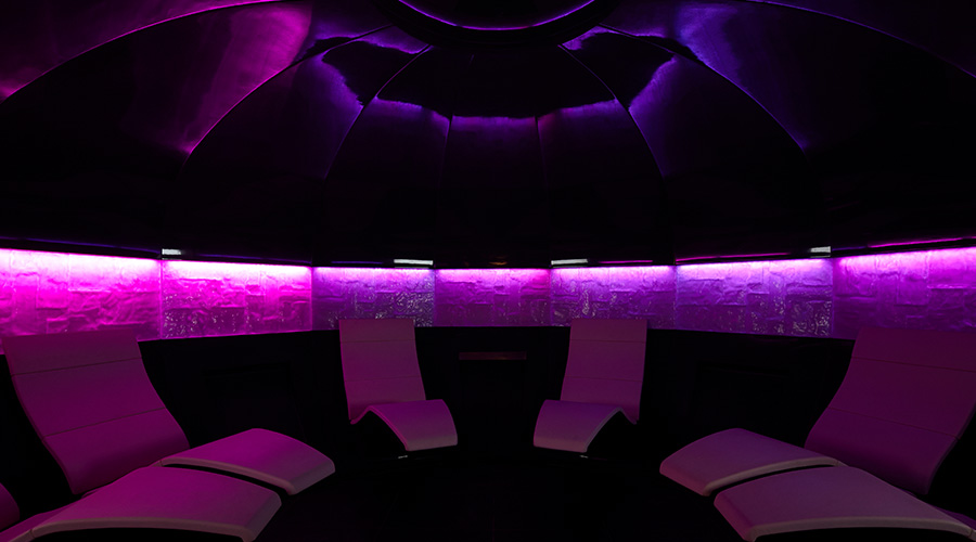 experience room with curved seats and purple lighting