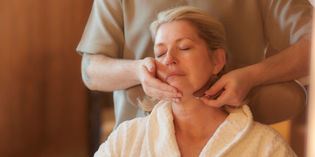 Woman having a massage with gua sha.
