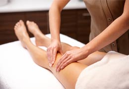 Therapist giving leg massage