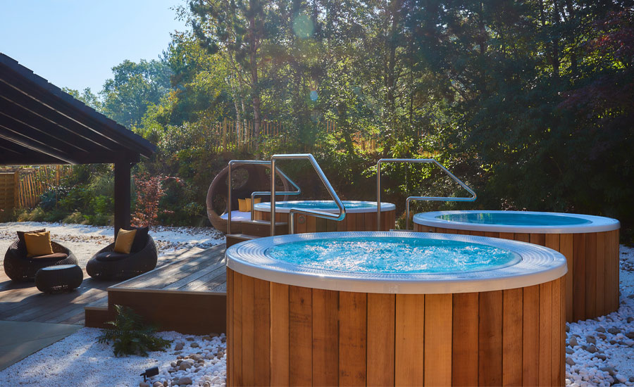 Outdoor bubbling hot tubs surrounded by the forest.