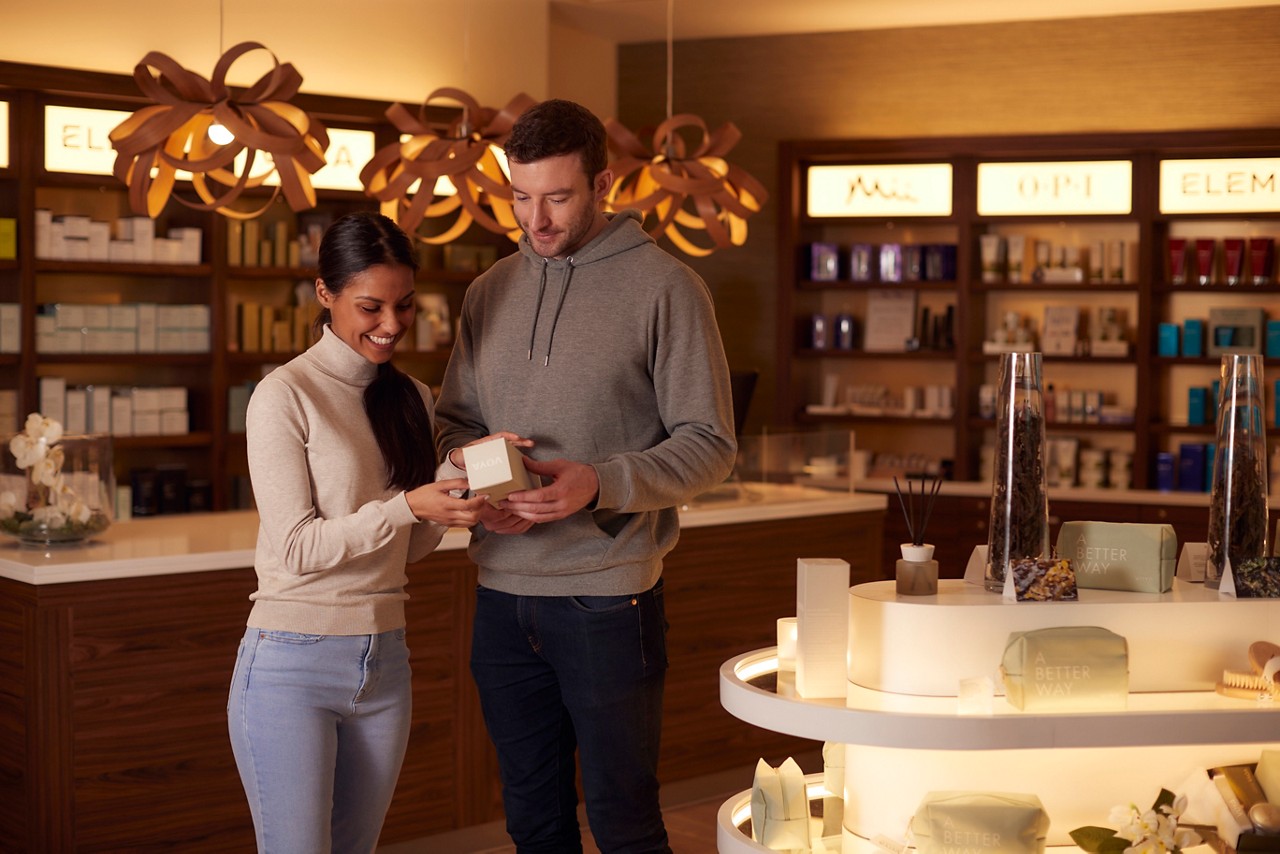 Couple browsing the spa and beauty products available inside the Aqua Sana Boutique.