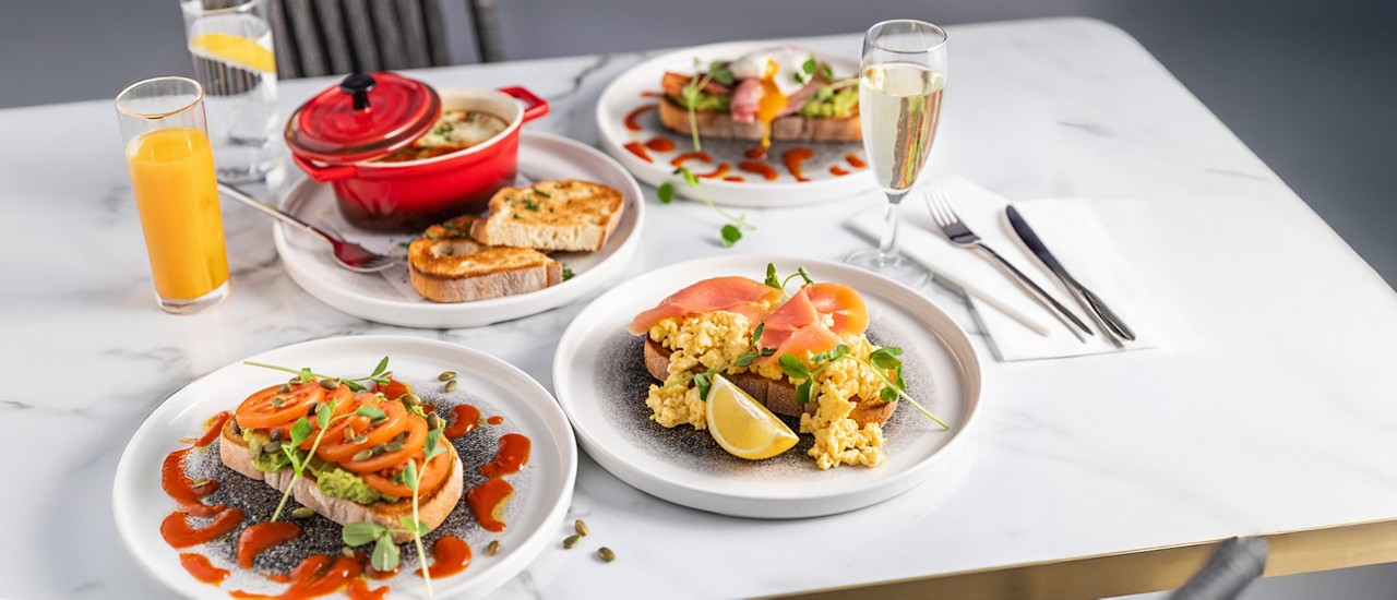 A selection of breakfast items including granola and fruit salad.