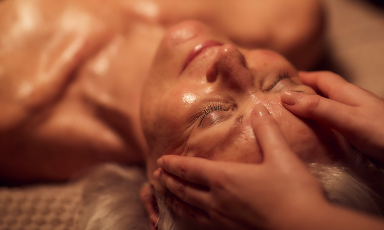 Woman having her head rubbed by a trained spa therapist.