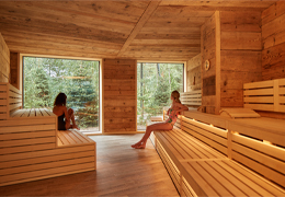 Two women sitting inside the Nordic Sauna