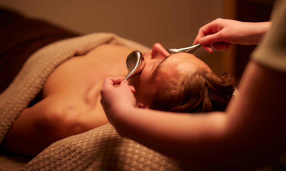 Woman having a facial with little brushes. 