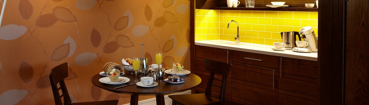 table and chairs next to the beverage station in the spa suite 