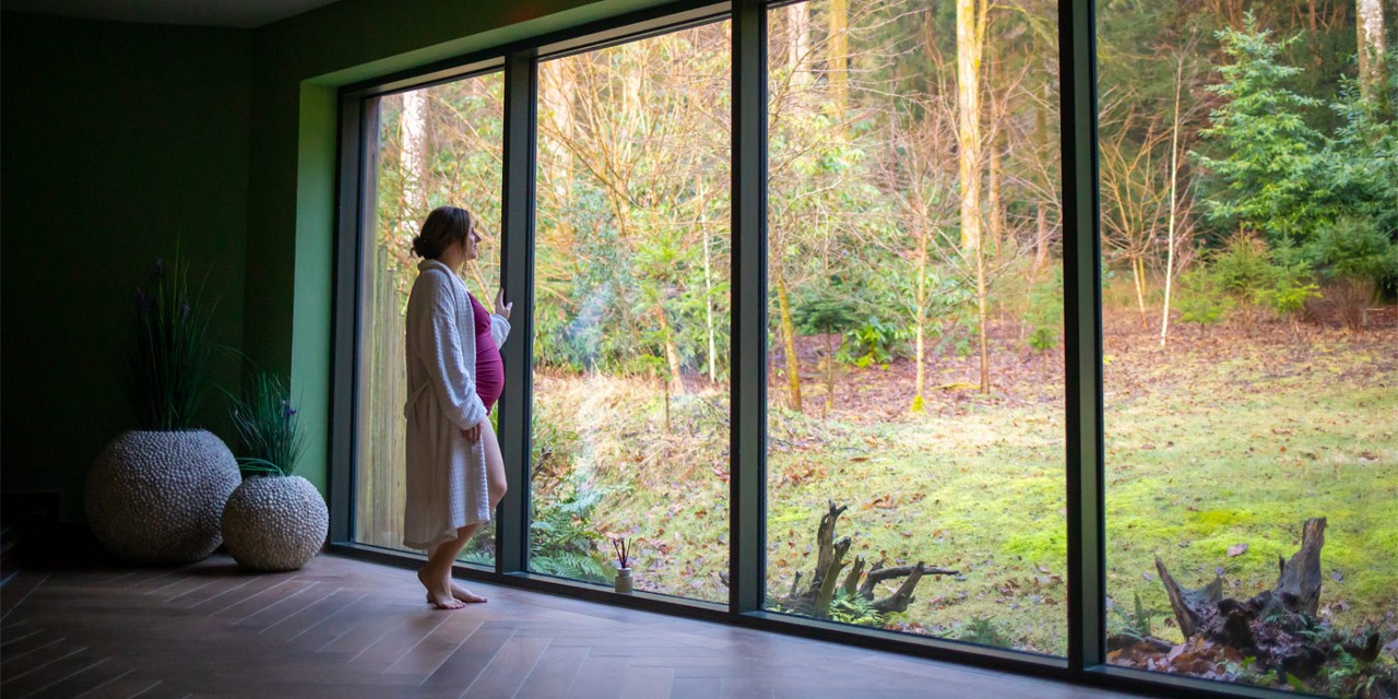 Woman looking out at the forest.