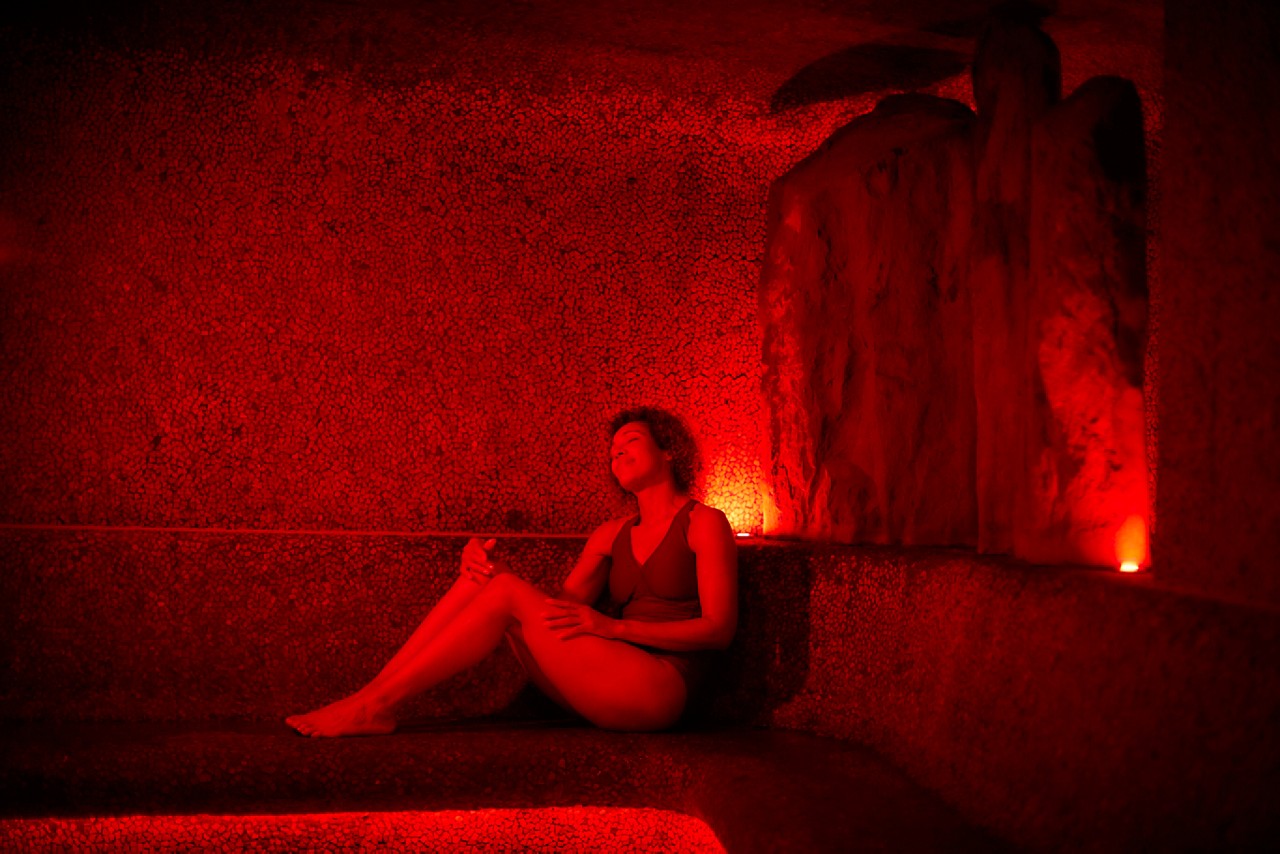 Woman relaxing in a glowing Volcanic Steam room.