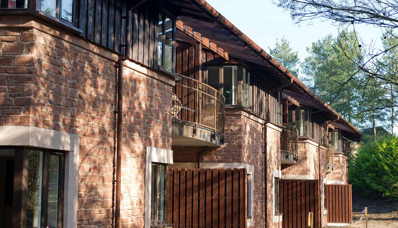 Exterior of Executive Apartments building surrounded by the forest.