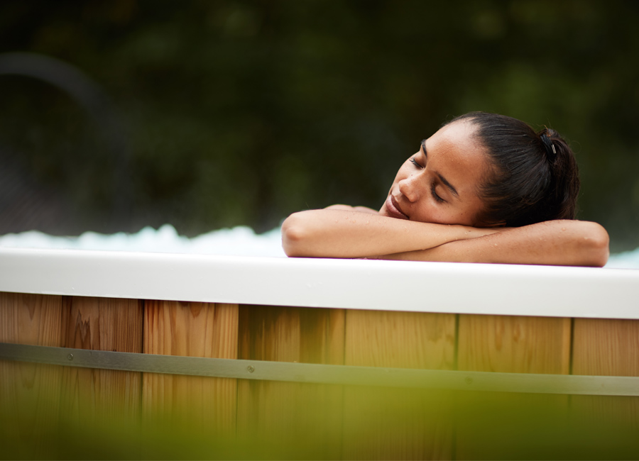 woman leaning on side of hot tub