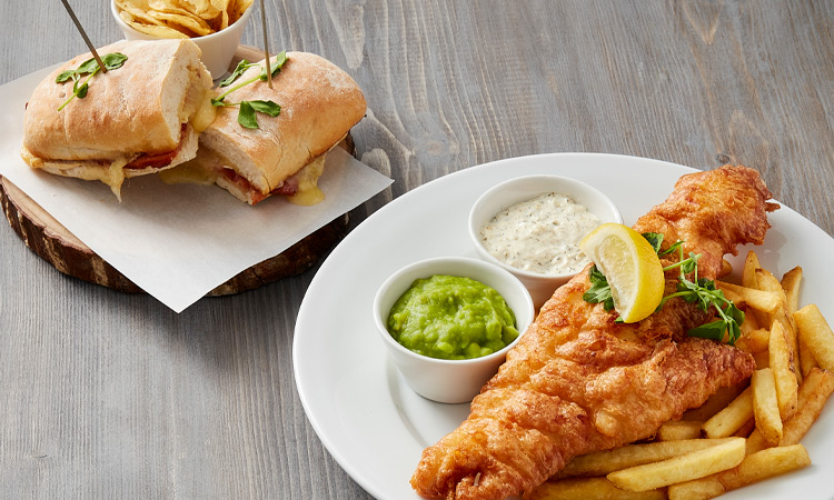 fish, chips, mushy peas, buttered bread and tartar sauce