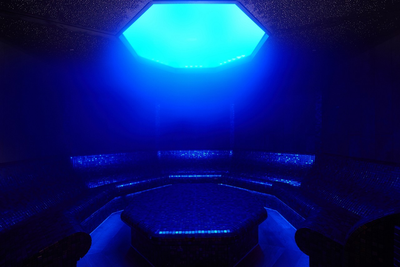 Oval room lit by moonlight with contoured seating.