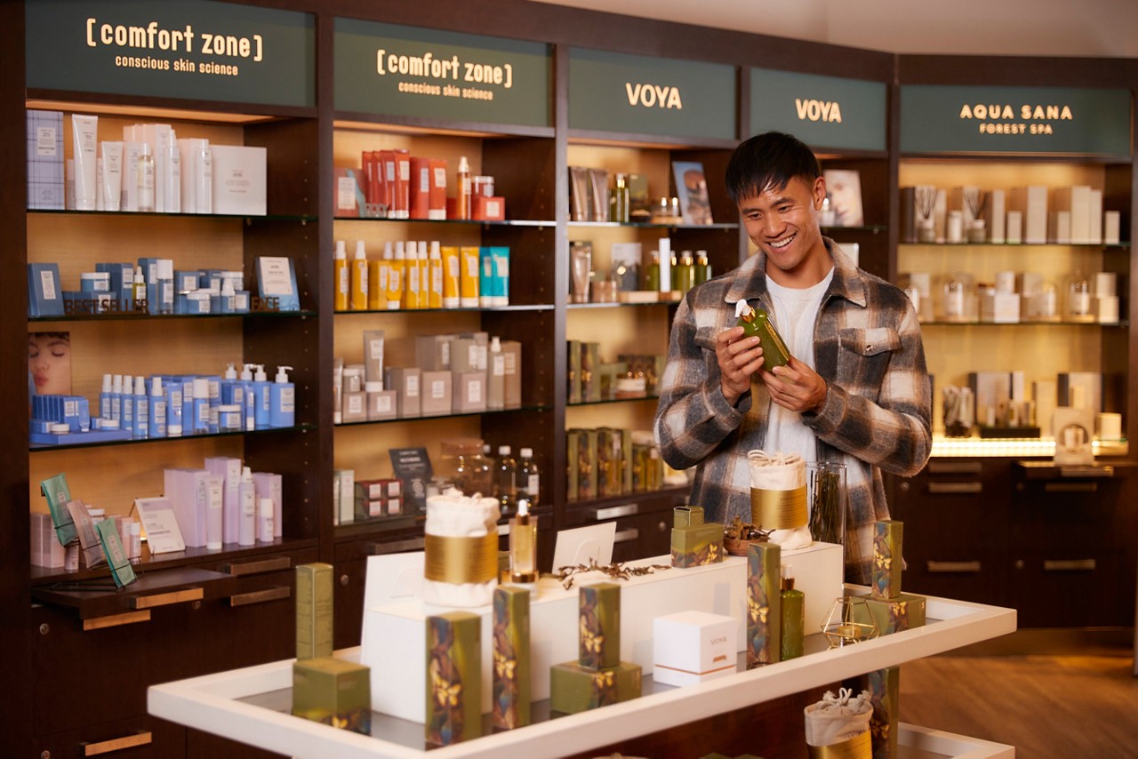 Man looking at products inside the Forest Spa Boutique.