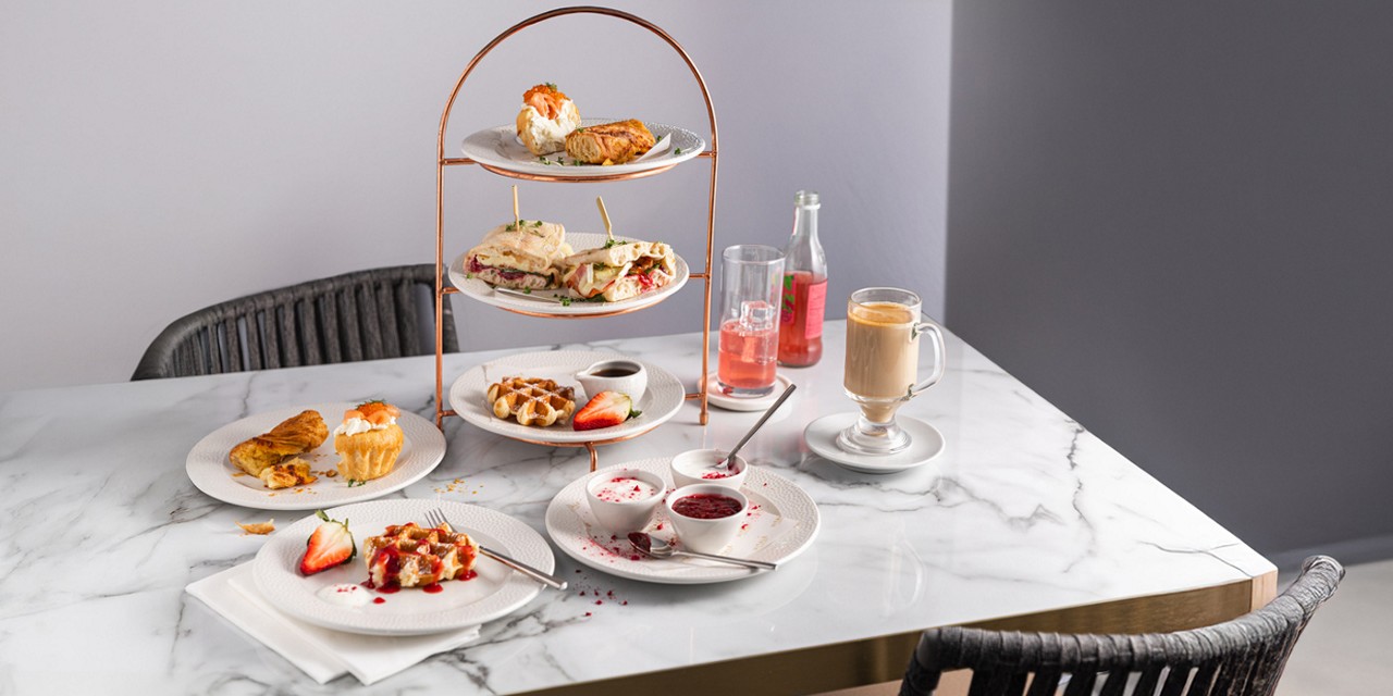 Breakfast platter served with warm drinks.