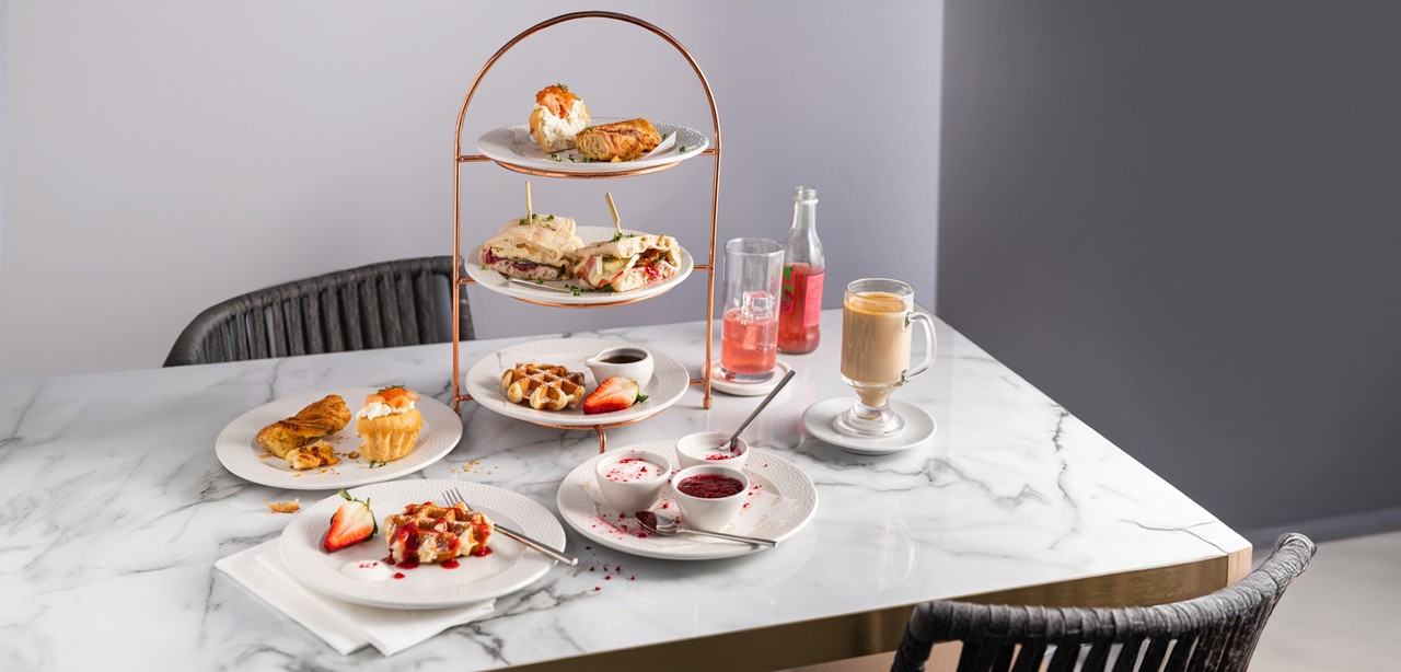 Breakfast platter served with warm drinks.