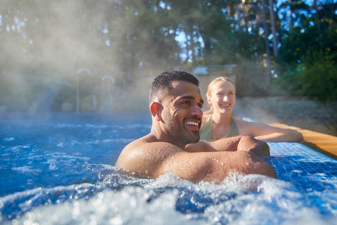 couple smiling in an outdoor pool