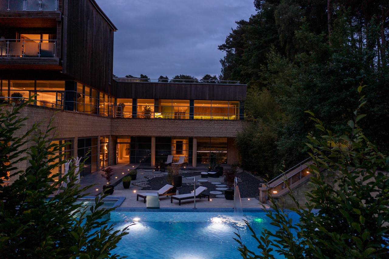 Outdoor Pool nestled in the forest, illuminated by the gentle evening light.