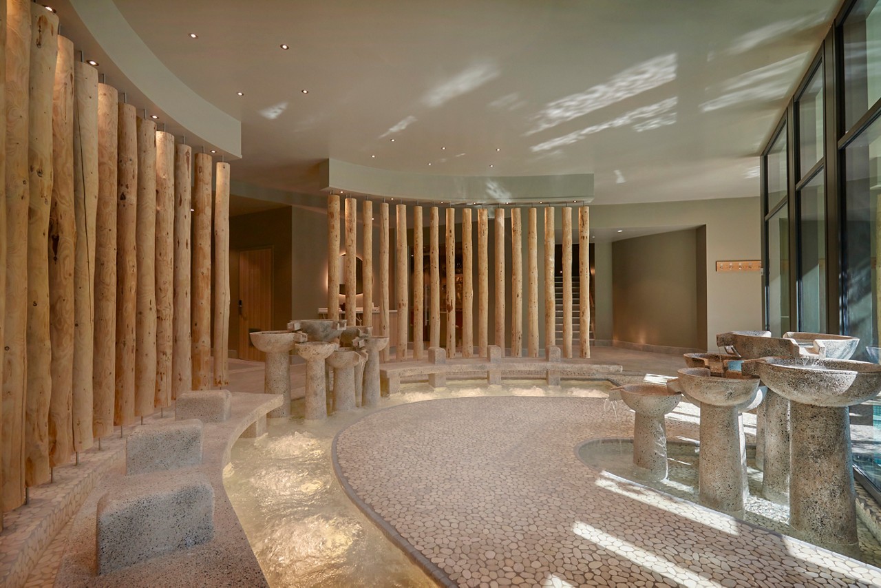 Flowing stone foot bath with views to the outdoor pool.