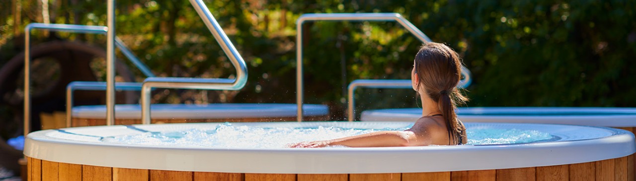 Woman sitting in a bubbling hot tub