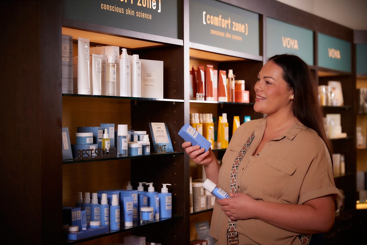 Women putting products on a shelf at Forest Spa Boutique