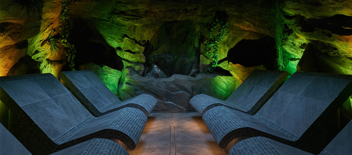 cavern inspired room with 6 seats and green light