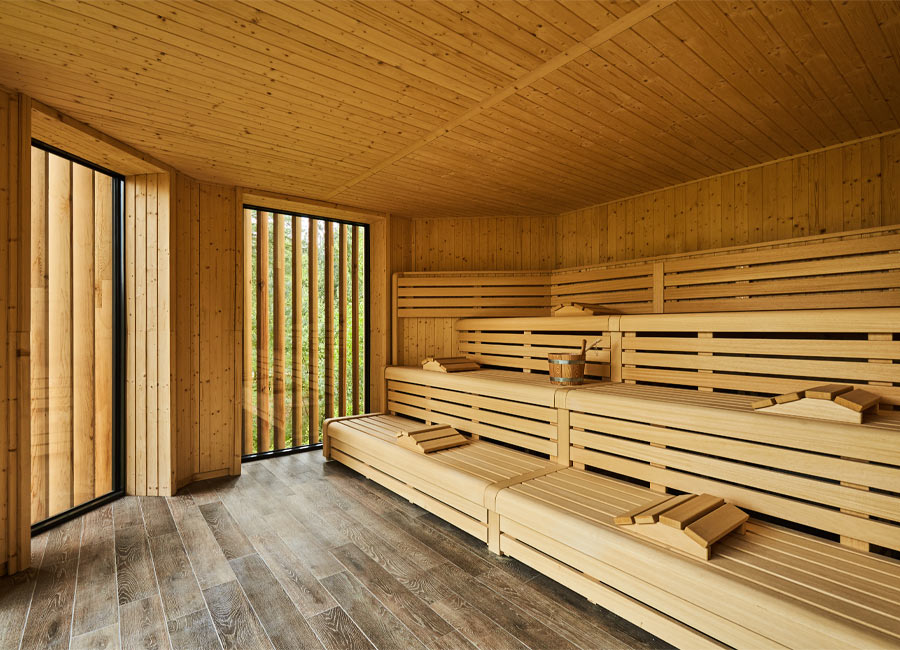 Inside of wooden sauna looking out to the treetops.