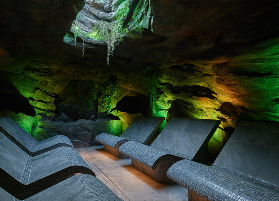 Inside a forest cavern with contoured seating.
