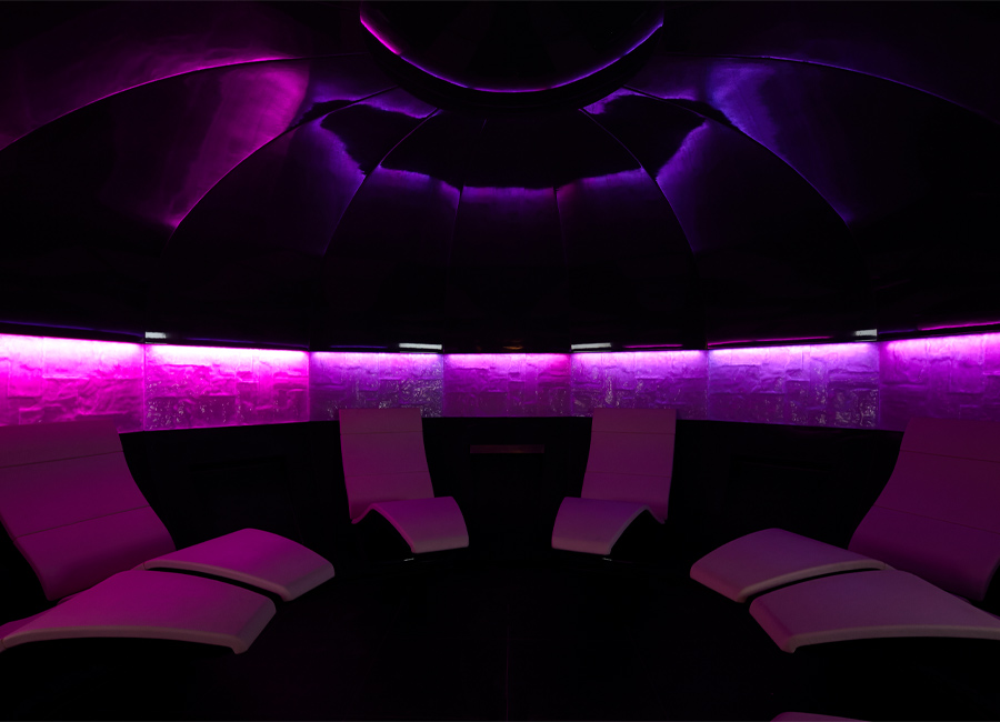 Round glowing mineral room with contoured seating.