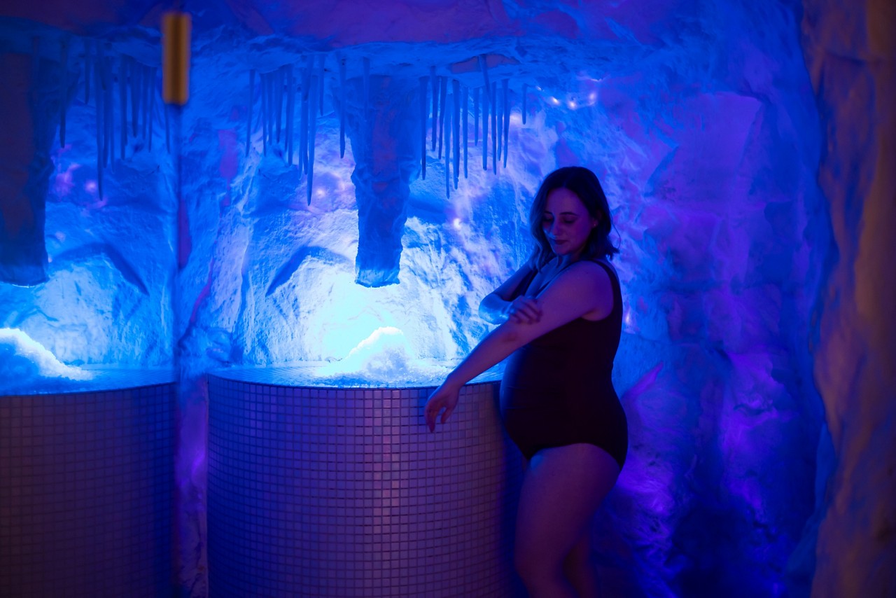 Woman leaning on the edge of a bubbling hot tub.