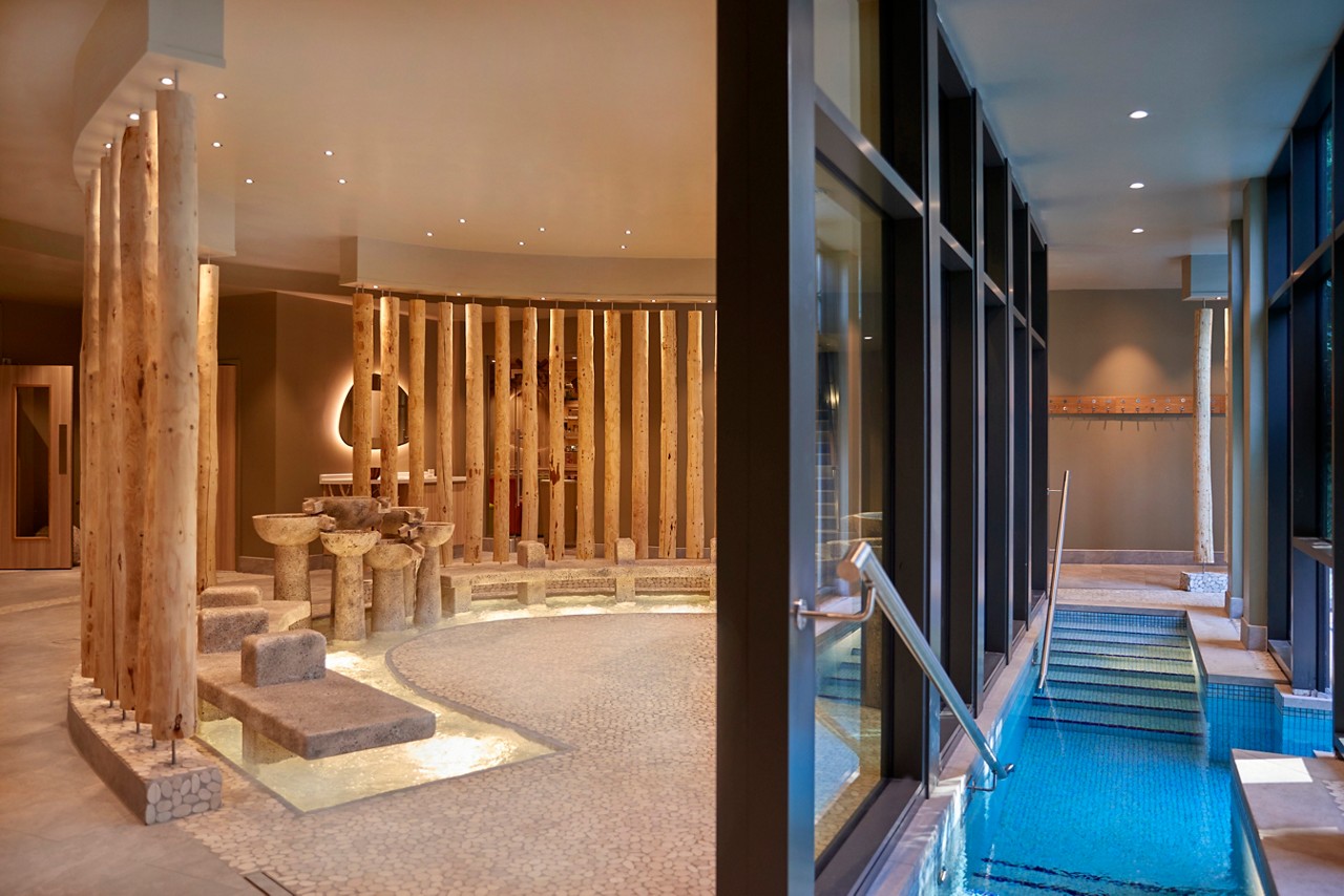 Flowing stone foot bath with views to the outdoor pool.