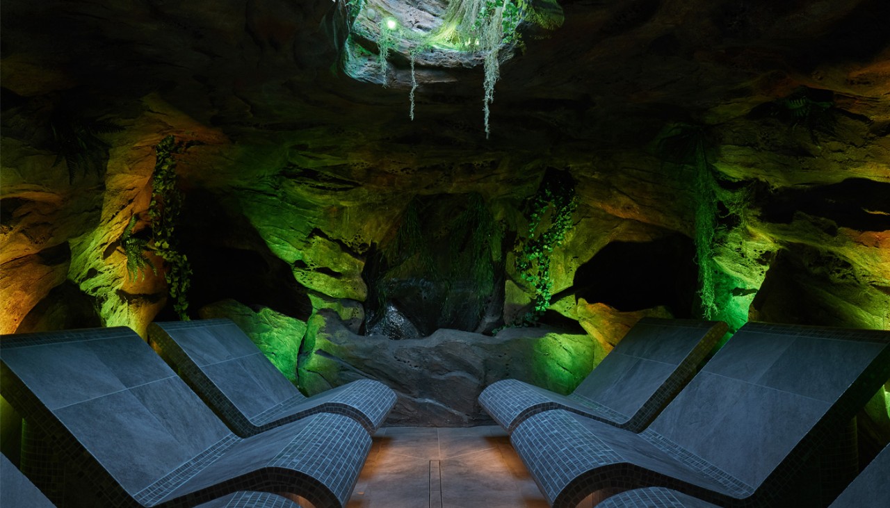Inside a forest cavern with contoured seating.