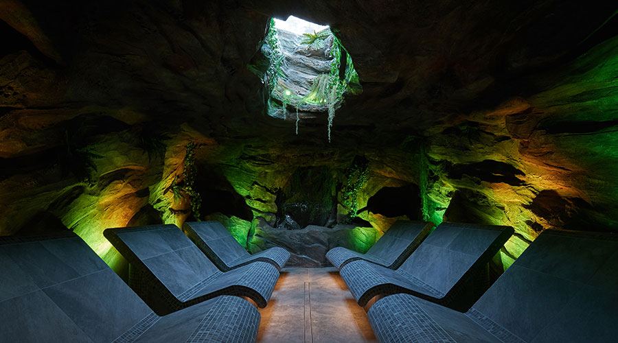 cavern experience room with curved seats and rock walls