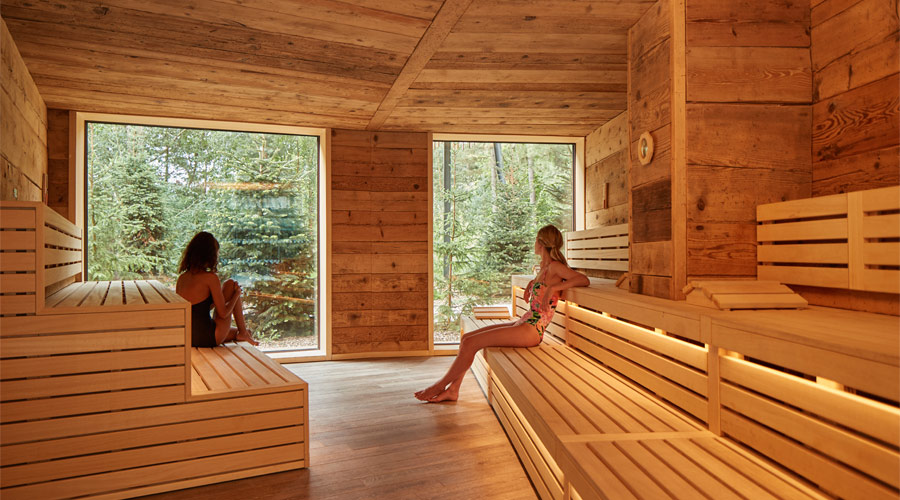 Two women sitting inside the Nordic Sauna