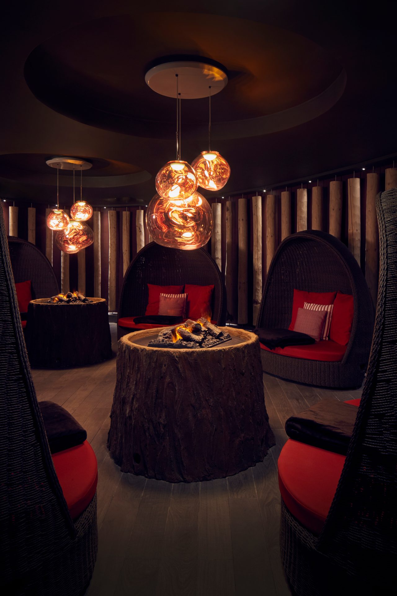 Fireside Relax room with glowing fires and large cocoon seating.