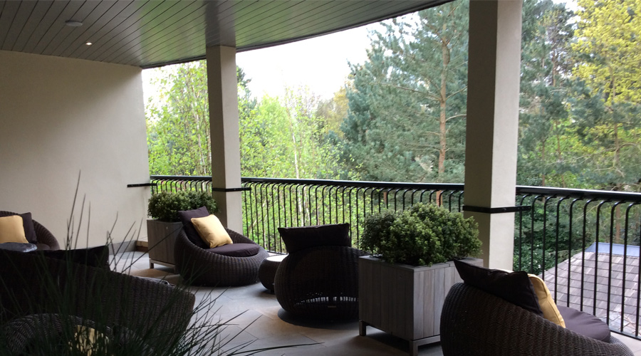 outdoor terrace with chairs overlooking forest