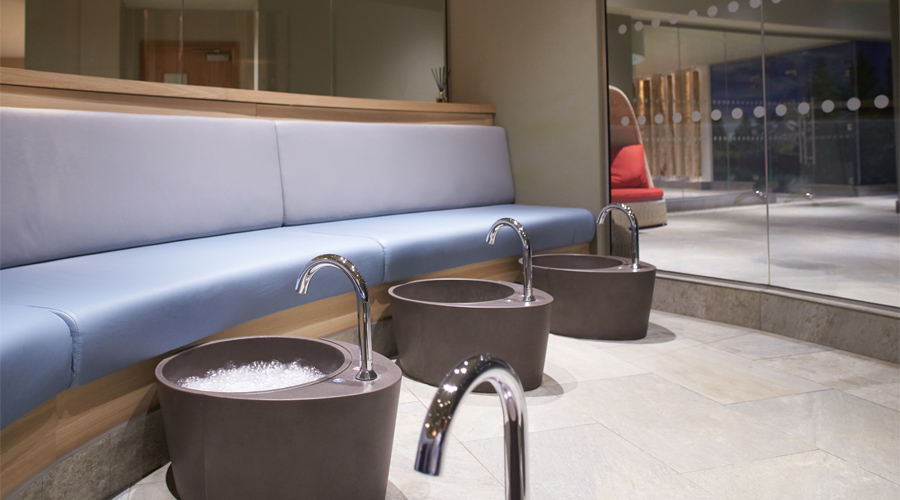Bubbling footbaths with curved bench seating.