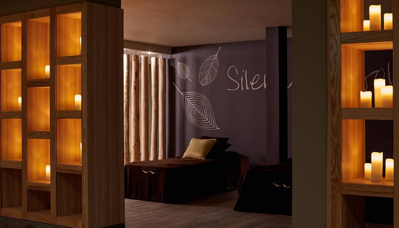 Comfortable waterbeds in a dim lit room with glowing candles.