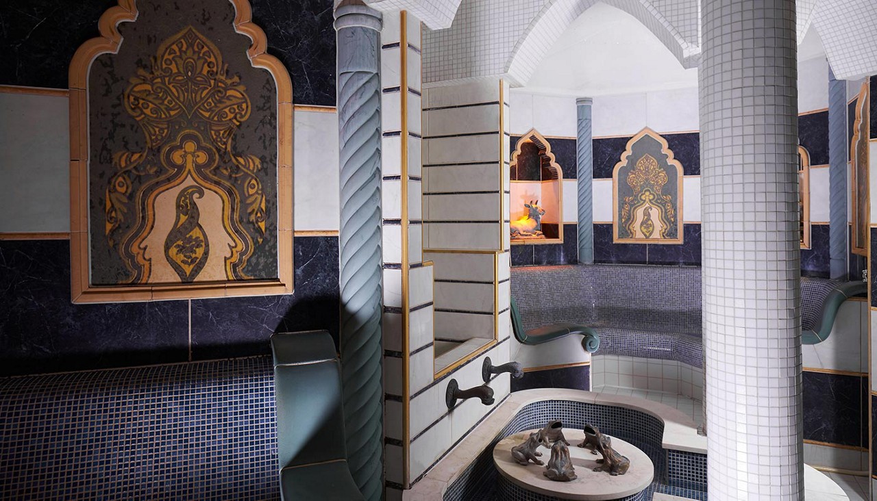 Decorative tiled room with artwork on the walls.