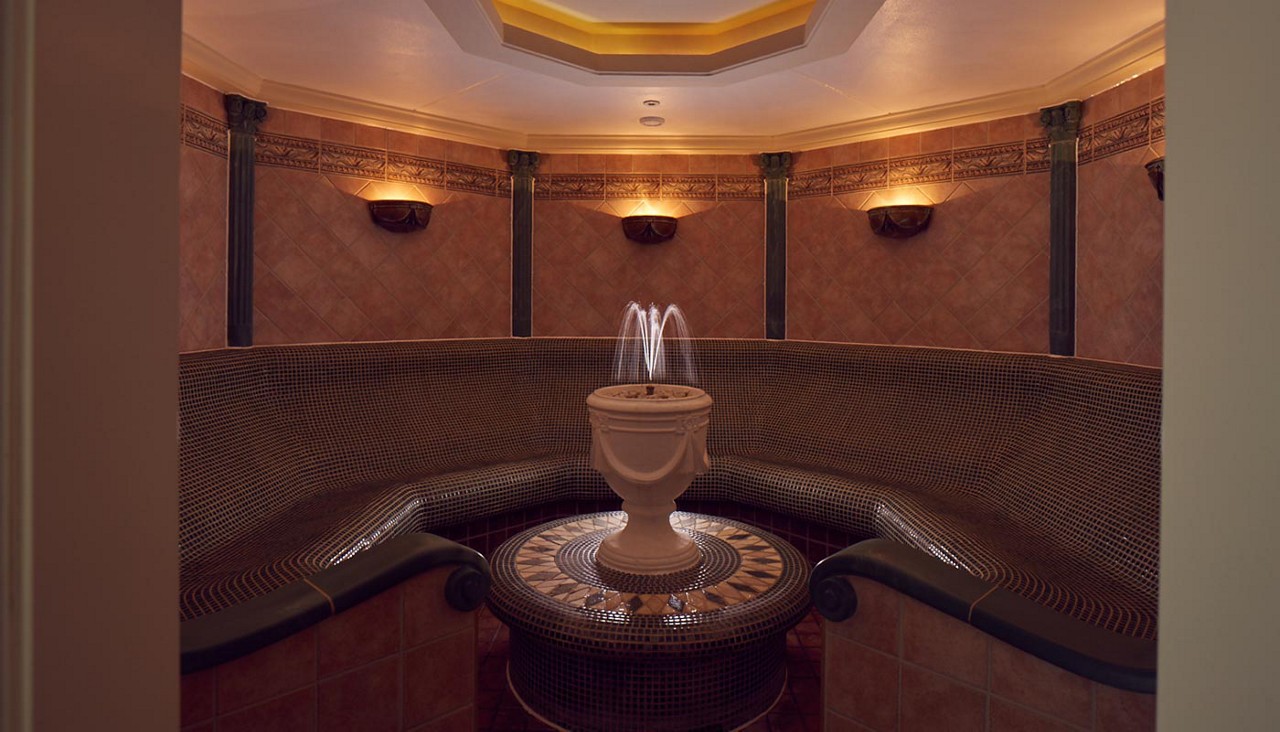 Curved seating surrounded by a flowing water fountain.