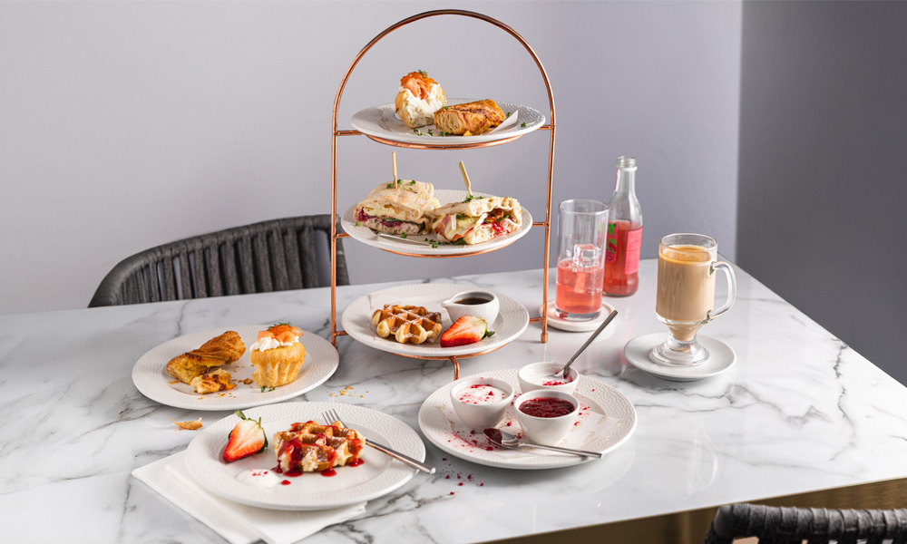 Stacked brunch served with a pot of tea.