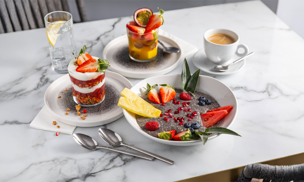 Marble table with a selection of sweet treats and beverages.