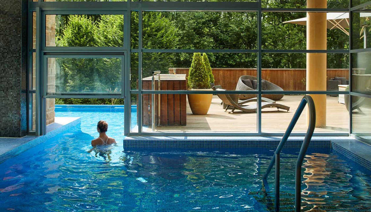 Woman swimming in an outdoor pool.