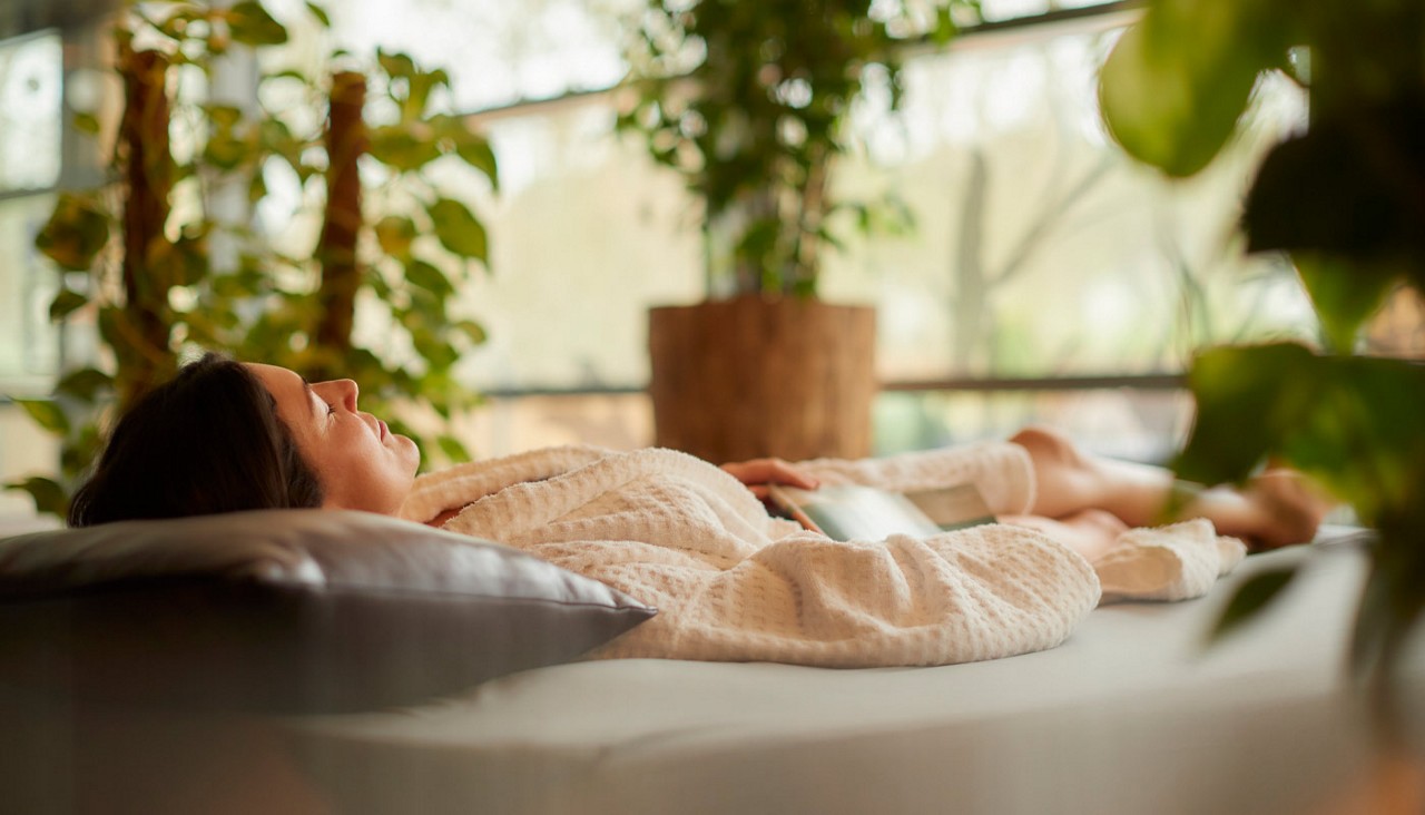 Lady laid on a Waterbed in a fluffy spa robe