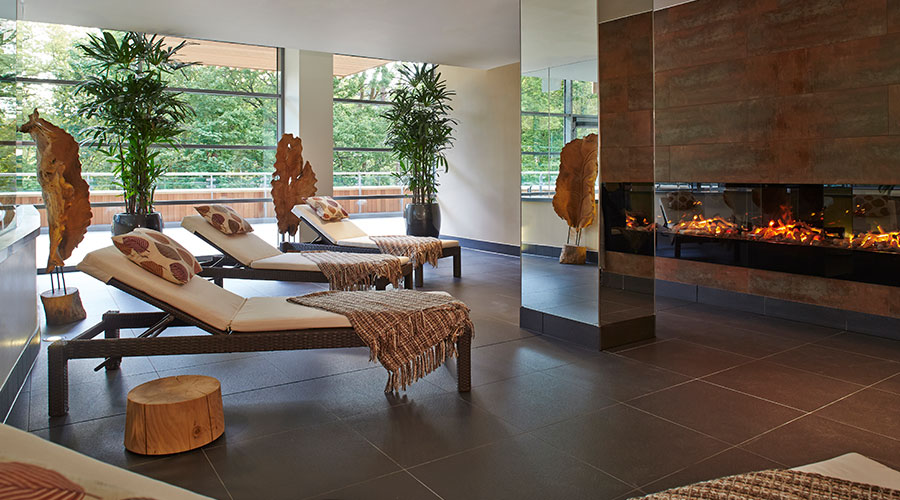 relax room with fire and lounge chairs with blankets