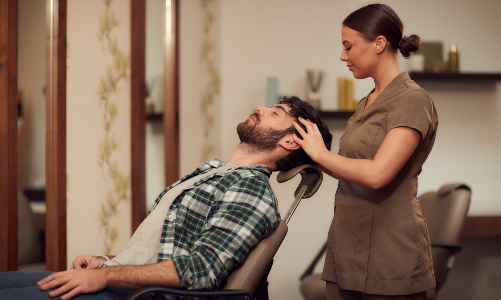 man receiving facial from therapist