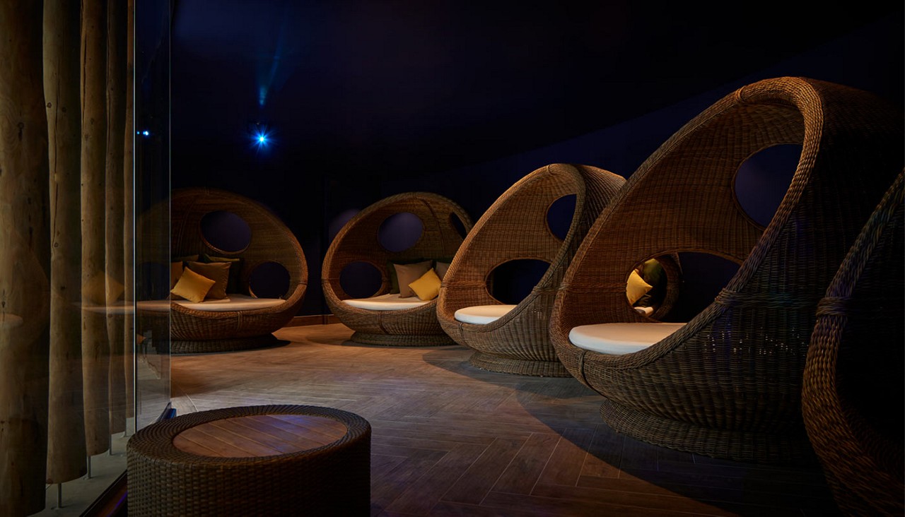 Cocoon seats in a dim lit room.