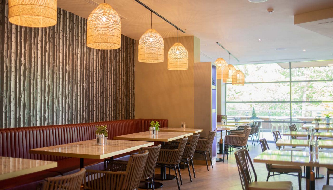 Interior of the Vitalé Café Bar with natural lighting, seating areas and subtle table decorations.