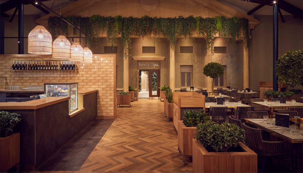 Inside the Vitalé Café Bar with foliage, soft lighting and places to eat.