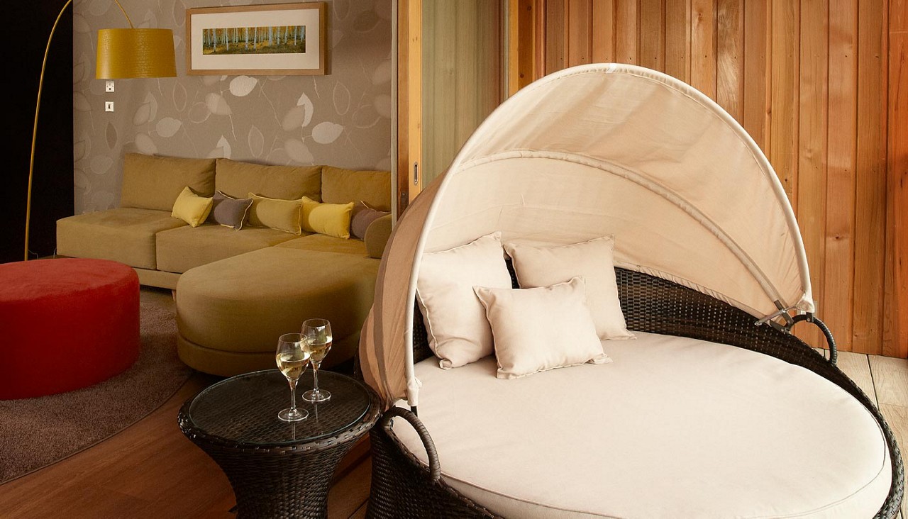 Balcony with a round lounging seat.